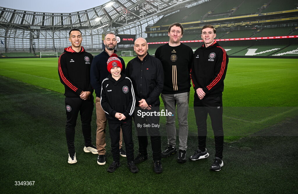 17 February 2026; In attendance at the announcement that Des Kelly Interiors have renewed their sponsorship of Bohemian FC are, from left, Bohemian FC player Douglas James-Taylor, Des Kelly Interiors managing director Greg Kelly, Kaiden Kelly, Des Kelly Interiors director Gerardo Kelly, Bohemian FC chief commercial officer Daniel Lambert, and Bohemian FC player Cian Byrne, at the Aviva Stadium in Dublin. Bohemian FC is delighted to confirm a three-year extension to our long-standing partnership with Des Kelly Interiors as the club’s main sponsor which is now agreed until the end of the 2028 season, a continuation of a relationship that now spans six decades. The renewed arrangement will see the Des Kelly Interiors name continue to be proudly displayed on the Bohs men’s teams home kit as well as adorning the jerseys of the club’s boys academy teams, extending their commitment to the wider Bohemian family. Photo by Seb Daly/Sportsfile