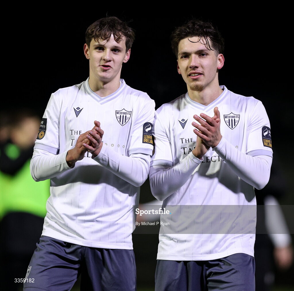 13 February 2026; Wexford players, from left, Ryan Butler and Zayd Abada acknowledges their supporters after the SSE Airtricity Men's First Division match between Cobh Ramblers and Wexford at St Colman's Park in Cobh, Cork. Photo by Michael P Ryan/Sportsfile
