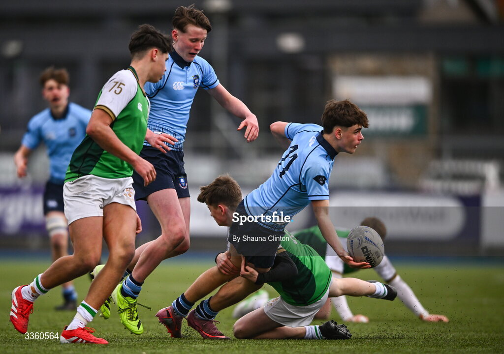 9 February 2026; Gabriel Kelly of St Michael's College offloads the ball despite the tackle of Seán Fehily of Gonzaga College during the Bank of Ireland Leinster Rugby Boys Schools Junior Cup First Round match between Gonzaga College and St Michael’s College at Energia Park in Dublin. Photo by Shauna Clinton/Sportsfile