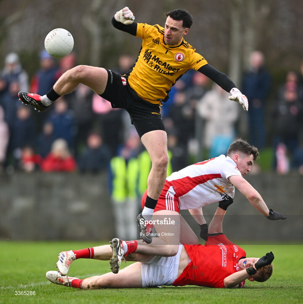 22 February 2026; Tyrone goalkeeper Niall Morgan makes a save as Eoin McElholm of Tyrone and Padraic Tinnelly of Louth collide during the Allianz Football League Division 2 match between Louth and Tyrone at DEFY Pairc Mhuire in Ardee, Louth. Photo by Shauna Clinton/Sportsfile