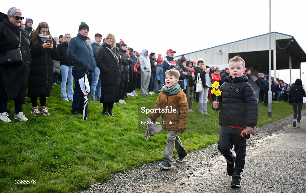 22 February 2026; Two young spectators collect daffodils during the Allianz Football League Division 2 match between Louth and Tyrone at DEFY Pairc Mhuire in Ardee, Louth. Photo by Shauna Clinton/Sportsfile