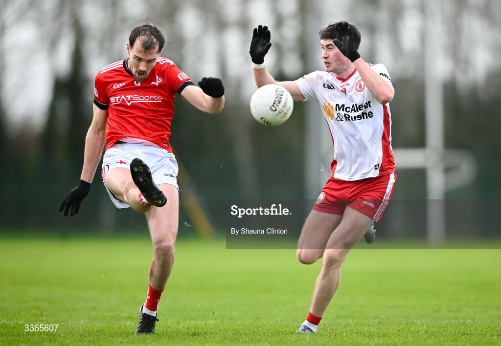 22 February 2026; Conor Early of Louth kicks a point despite the efforts of Ciarán Daly of Tyrone during the Allianz Football League Division 2 match between Louth and Tyrone at DEFY Pairc Mhuire in Ardee, Louth. Photo by Shauna Clinton/Sportsfile
