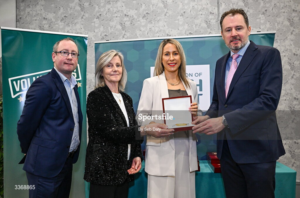 26 February 2026; Kate Ryan of Tallow GAA & Camogie, Waterford, is presented with her award by Minister of State at the Department of Culture, Communications and Sport Charlie McConalogue TD, Federation of Irish Sport chair Clare McGrath, and Dun Laoghaire Rathdown Sports Partnership coordinator Shane McArdle, during the Volunteers in Sport Awards 2025, hosted by the Federation of Irish Sport and supported by the National Network of 29 Local Sports Partnerships, at The Crowne Plaza Hotel in Blanchardstown, Dublin. Photo by Seb Daly/Sportsfile