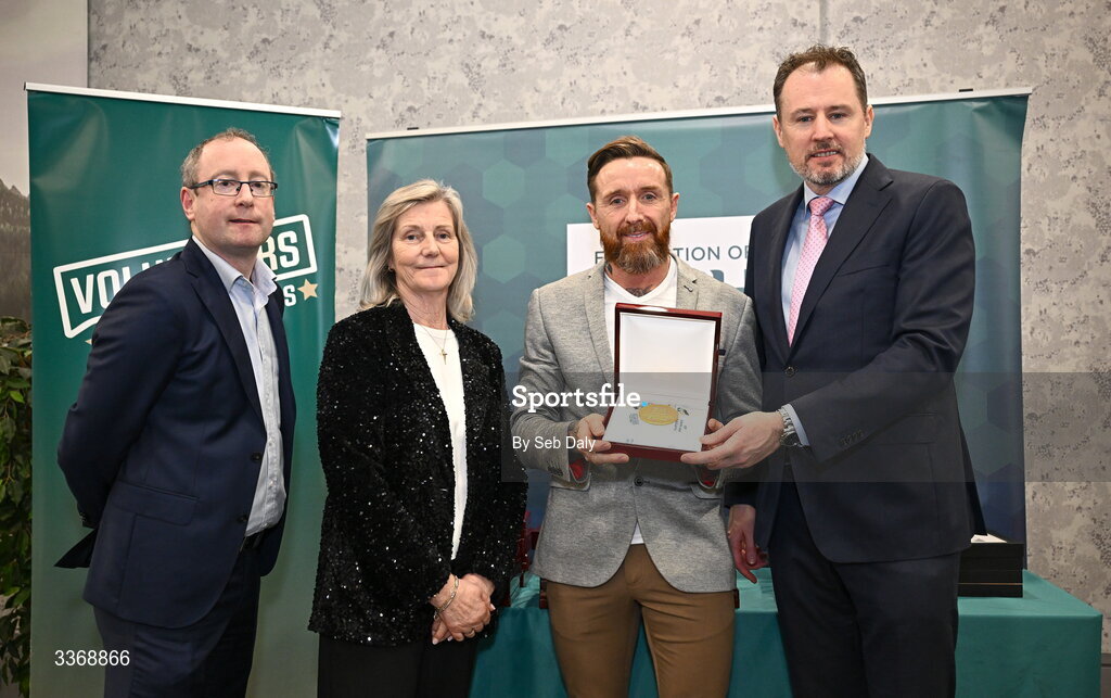 26 February 2026; Ger Redmond of Coolock Running Club, Dublin City, is presented with his award by Minister of State at the Department of Culture, Communications and Sport Charlie McConalogue TD, Federation of Irish Sport chair Clare McGrath, and Dun Laoghaire Rathdown Sports Partnership coordinator Shane McArdle, during the Volunteers in Sport Awards 2025, hosted by the Federation of Irish Sport and supported by the National Network of 29 Local Sports Partnerships, at The Crowne Plaza Hotel in Blanchardstown, Dublin. Photo by Seb Daly/Sportsfile