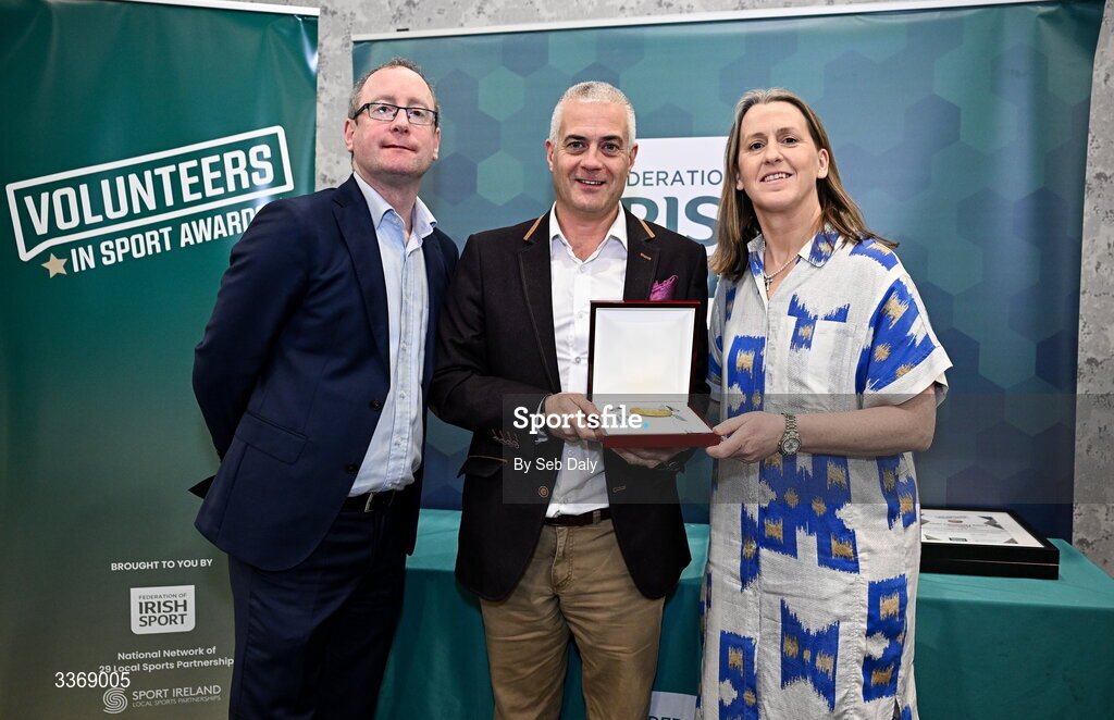 26 February 2026; Ronan Butler of St Mary’s Kiltoghert GAA Club, Leitrim, is presented with his award by Federation of Irish Sport chief executive officer Mary O'Connor, and Dun Laoghaire Rathdown Sports Partnership coordinator Shane McArdle, during the Volunteers in Sport Awards 2025, hosted by the Federation of Irish Sport and supported by the National Network of 29 Local Sports Partnerships, at The Crowne Plaza Hotel in Blanchardstown, Dublin. Photo by Seb Daly/Sportsfile