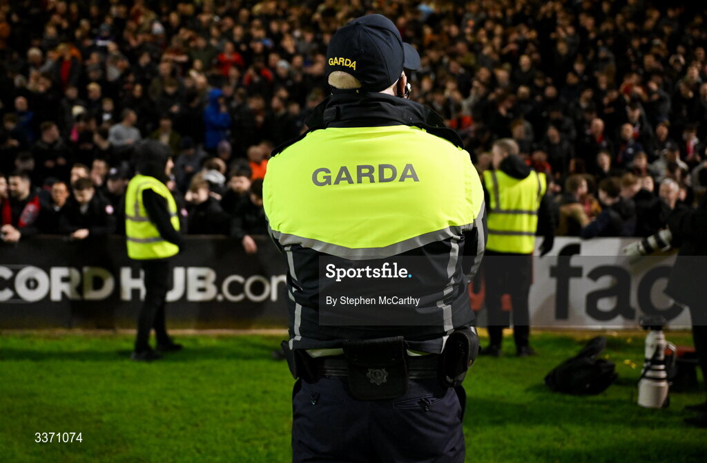 27 February 2026; A Member of An Garda Síochána stands infront of Bohemians supporters after the SSE Airtricity Men's Premier Division match between Bohemians and Shamrock Rovers at Dalymount Park in Dublin. Photo by Stephen McCarthy/Sportsfile