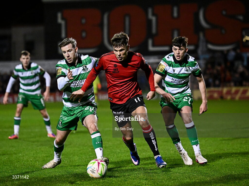 27 February 2026; Dayle Rooney of Bohemians in action against Shamrock Rovers players Jack Byrne, left, and Cory O'Sullivan during the SSE Airtricity Men's Premier Division match between Bohemians and Shamrock Rovers at Dalymount Park in Dublin. Photo by Seb Daly/Sportsfile