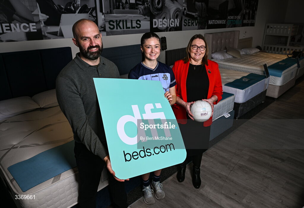 5 March 2026; Dublin ladies footballer Hannah McGinnis poses for a portrait alongside DFI managing director Brian McCann, left, and LGFA president Trina Murray at DFI Beds in Newry as DFI Beds announce the Dublin star as the new LGFA sleep ambassador. Photo by Ben McShane/Sportsfile