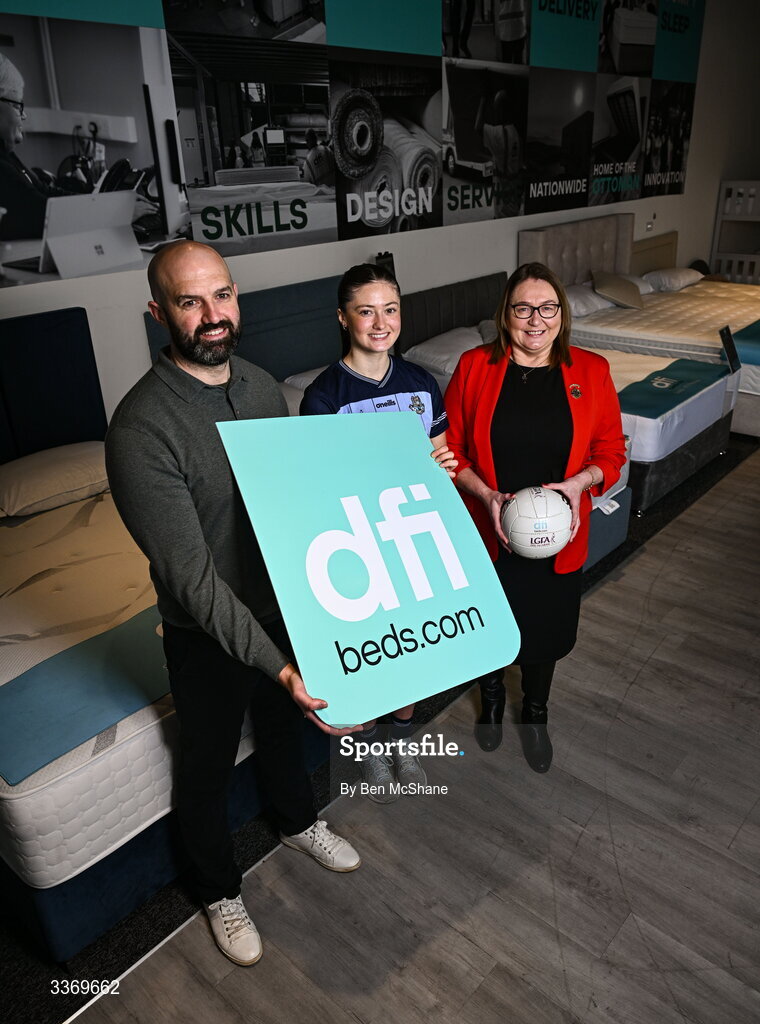 5 March 2026; Dublin ladies footballer Hannah McGinnis poses for a portrait alongside DFI managing director Brian McCann, left, and LGFA president Trina Murray at DFI Beds in Newry as DFI Beds announce the Dublin star as the new LGFA sleep ambassador. Photo by Ben McShane/Sportsfile