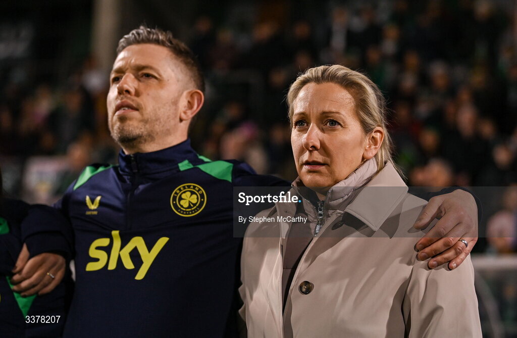 3 March 2026; Republic of Ireland head coach Carla Ward and assistant coach Gary Cronin, left, stand for Amhrán na bhFiann before the 2027 FIFA Women’s World Cup Qualifier match between Republic of Ireland and France at Tallaght Stadium in Dublin. Photo by Stephen McCarthy/Sportsfile