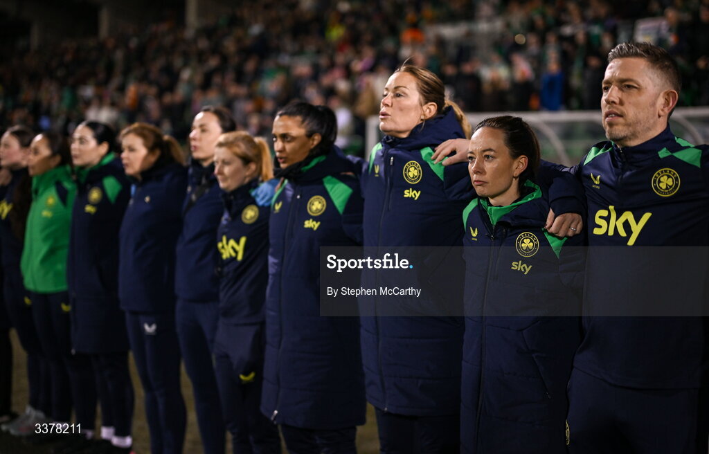 3 March 2026; Republic of Ireland coaches, from right, assistant coach Gary Cronin, assistant coach Amber Whiteley, goalkeeping coach Emma Byrne, performance analyst Jasmine Mander and performance coach Holly Pickett stand for Amhrán na bhFiann before the 2027 FIFA Women’s World Cup Qualifier match between Republic of Ireland and France at Tallaght Stadium in Dublin. Photo by Stephen McCarthy/Sportsfile