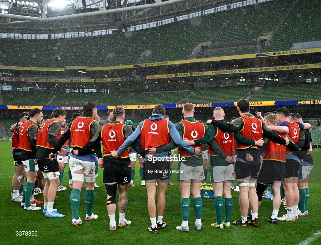 5 March 2026; The Ireland team huddle amid heavy rain during their captain's run at the Aviva Stadium in Dublin. Photo by Brendan Moran/Sportsfile