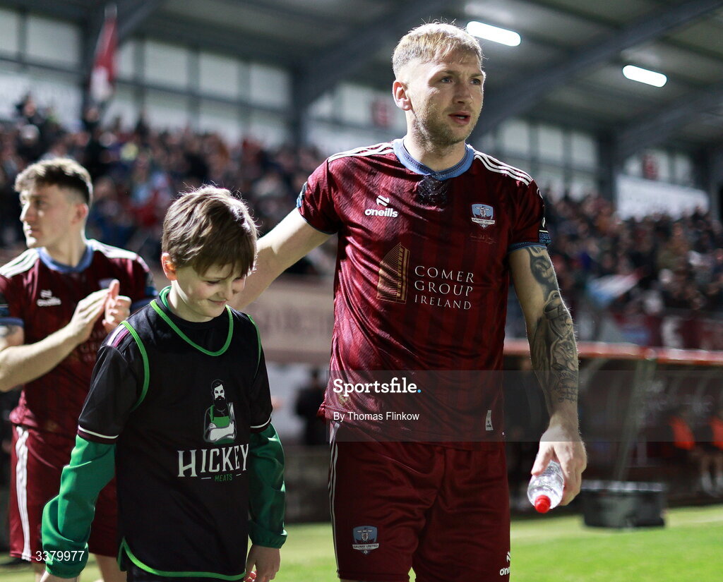 6 March 2026; Stephen Walsh of Galway United enters the pitch with a mascot before the SSE Airtricity Men's Premier Division match between Galway United and Dundalk at Eamonn Deacy Park in Galway. Photo by Thomas Flinkow/Sportsfile