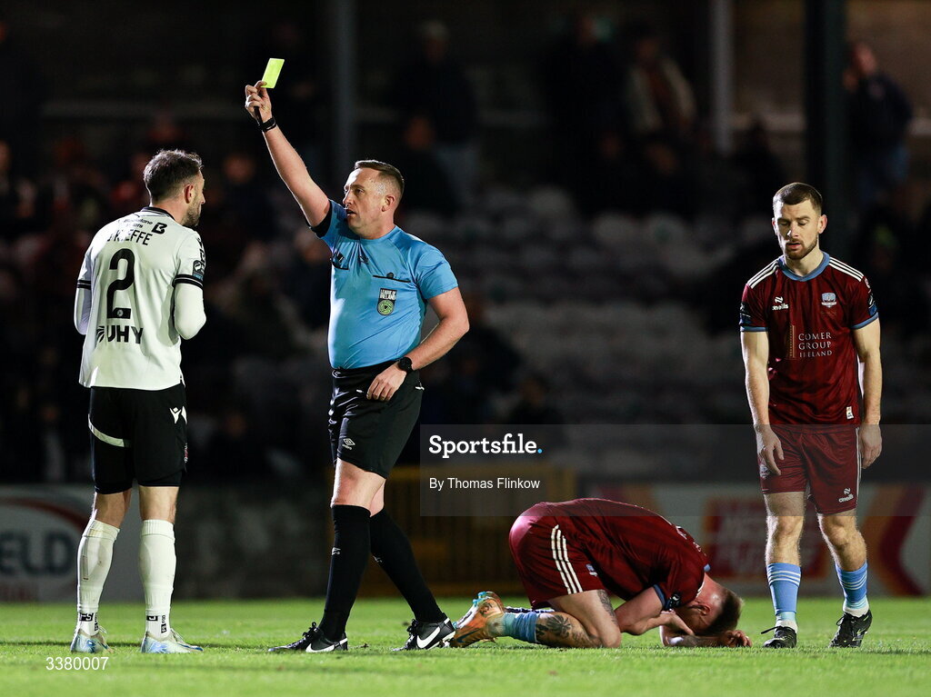 6 March 2026; Referee Alan Patchell shows a yellow card to Conor O'Keefe of Dundalk during the SSE Airtricity Men's Premier Division match between Galway United and Dundalk at Eamonn Deacy Park in Galway. Photo by Thomas Flinkow/Sportsfile
