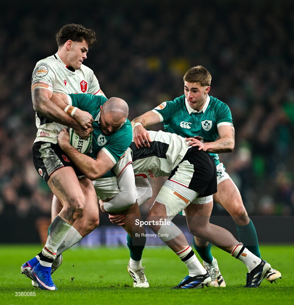 6 March 2026; Jacob Stockdale of Ireland is tackled by Wales players Eddie James, left, and Ellis Mee during the Guinness 6 Nations Rugby Championship match between Ireland and Wales at the Aviva Stadium in Dublin. Photo by Ramsey Cardy/Sportsfile