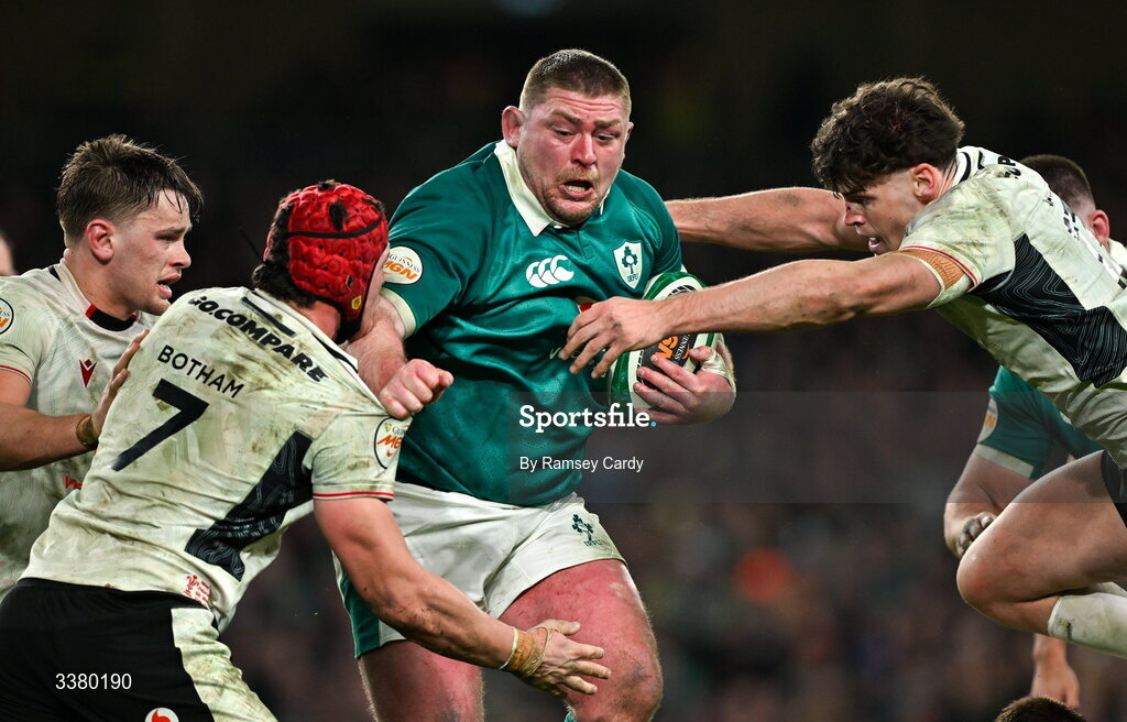 6 March 2026; Tadhg Furlong of Ireland is tackled by Wales players James Botham, left, and Eddie James during the Guinness 6 Nations Rugby Championship match between Ireland and Wales at the Aviva Stadium in Dublin. Photo by Ramsey Cardy/Sportsfile