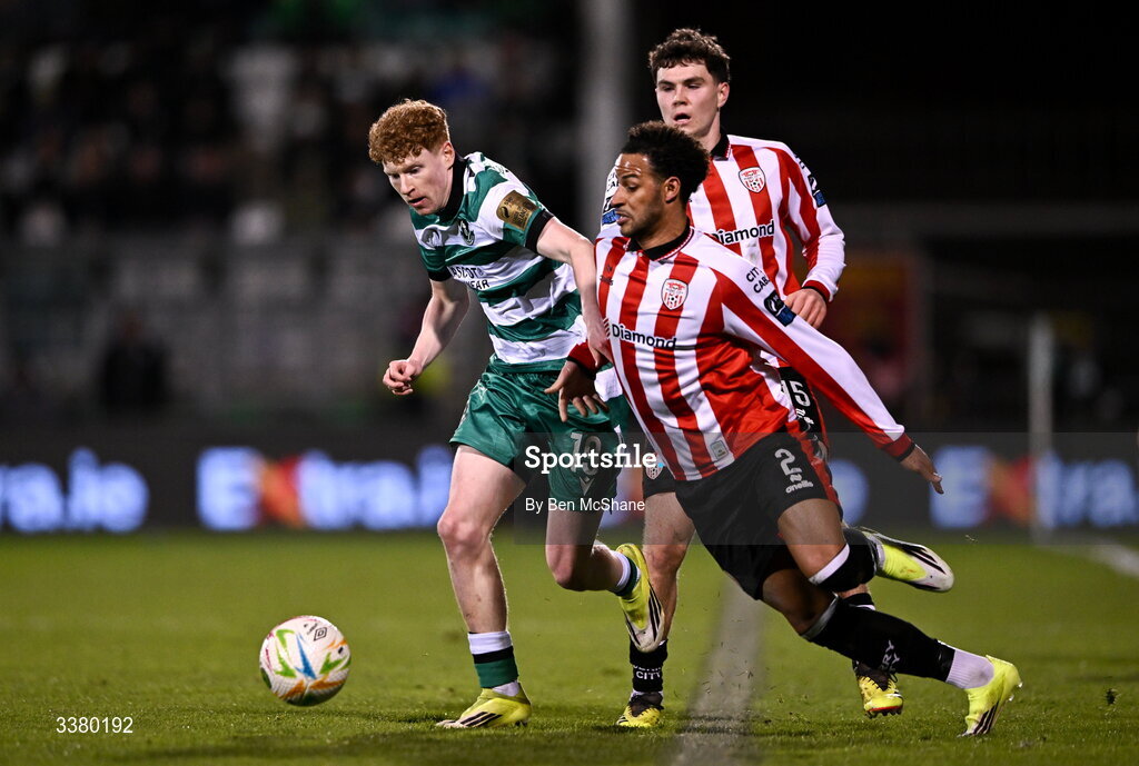 6 March 2026; Adam Brennan of Shamrock Rovers in action against Barry Cotter, front, and James Clarke of Derry City during the SSE Airtricity Men's Premier Division match between Shamrock Rovers and Derry City at Tallaght Stadium in Dublin. Photo by Ben McShane/Sportsfile