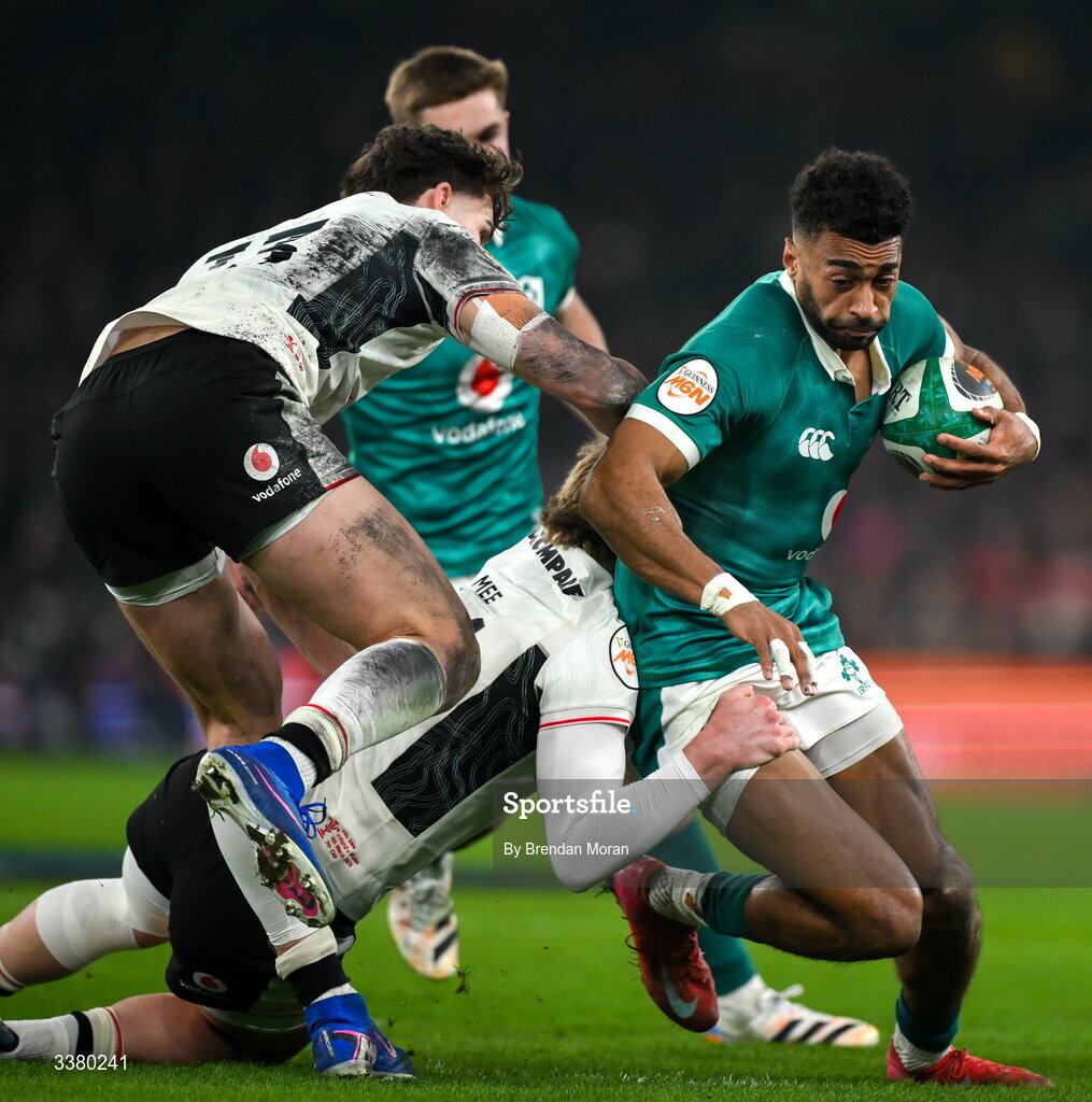 6 March 2026; Robert Baloucoune of Ireland is tackled by Wales players Eddie James, left, and Ellis Mee during the Guinness 6 Nations Rugby Championship match between Ireland and Wales at the Aviva Stadium in Dublin. Photo by Brendan Moran/Sportsfile