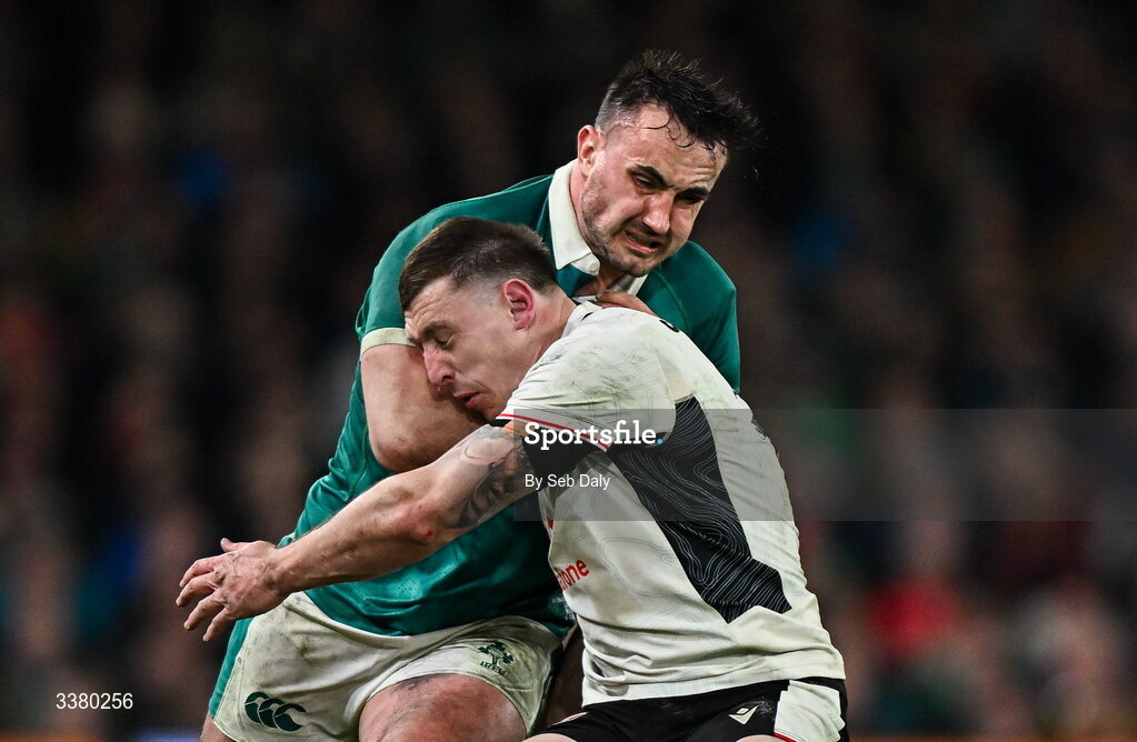 6 March 2026; Rónan Kelleher of Ireland is tackled by Josh Adams of Wales during the Guinness 6 Nations Rugby Championship match between Ireland and Wales at the Aviva Stadium in Dublin. Photo by Seb Daly/Sportsfile