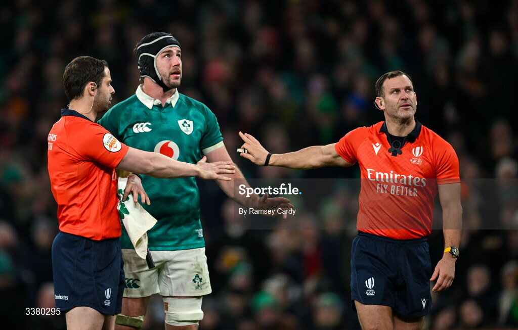6 March 2026; Ireland captain Caelan Doris, centre, with referee Karl Dickson, right, and assistant referee Nika Amashukeli during the Guinness 6 Nations Rugby Championship match between Ireland and Wales at the Aviva Stadium in Dublin. Photo by Ramsey Cardy/Sportsfile