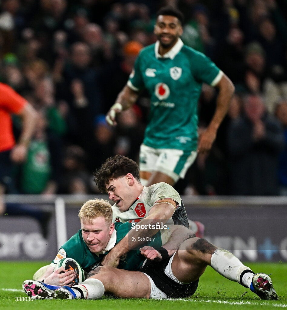 6 March 2026; Jamie Osborne of Ireland scores his side's fourth try despite the efforts from Eddie James of Wales during the Guinness 6 Nations Rugby Championship match between Ireland and Wales at the Aviva Stadium in Dublin. Photo by Seb Daly/Sportsfile