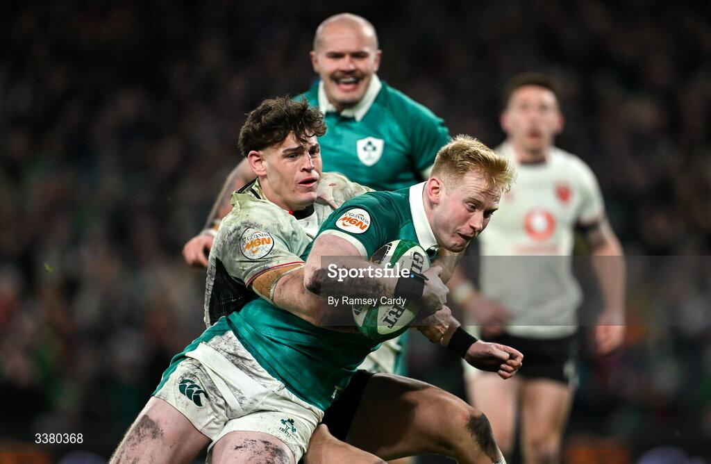 6 March 2026; Jamie Osborne of Ireland on his way to scoring his side's fourth try despite the tackle of Eddie James of Wales during the Guinness 6 Nations Rugby Championship match between Ireland and Wales at the Aviva Stadium in Dublin. Photo by Ramsey Cardy/Sportsfile