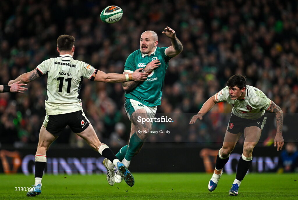 6 March 2026; Jacob Stockdale of Ireland offloads under pressure from Josh Adams of Wales during the Guinness 6 Nations Rugby Championship match between Ireland and Wales at the Aviva Stadium in Dublin. Photo by Ramsey Cardy/Sportsfile