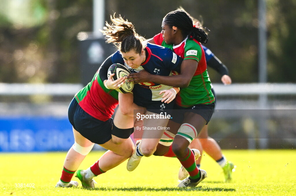 7 March 2026; Eve Higgins of Wolfhounds is tackled by Clovers players Siobhán McCarthy, left, and Faith Oviawe during the Celtic Challenge Round 10 match between Wolfhounds and Clovers at Belfield Bowl in Dublin. Photo by Shauna Clinton/Sportsfile