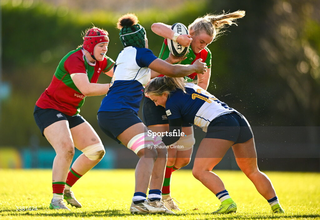 7 March 2026; Ailish Quinn of Clovers is tackled by Wolfhounds players Grace Moore, left, and Aoife Dalton during the Celtic Challenge Round 10 match between Wolfhounds and Clovers at Belfield Bowl in Dublin. Photo by Shauna Clinton/Sportsfile