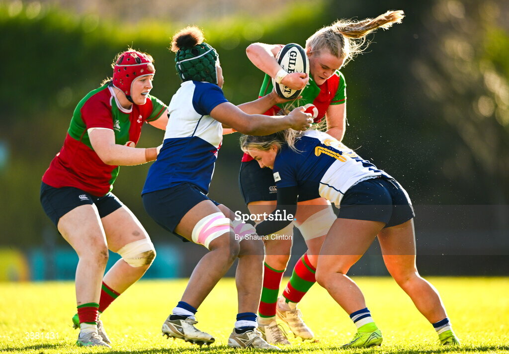 7 March 2026; Ailish Quinn of Clovers is tackled by Wolfhounds players Grace Moore, left, and Aoife Dalton during the Celtic Challenge Round 10 match between Wolfhounds and Clovers at Belfield Bowl in Dublin. Photo by Shauna Clinton/Sportsfile