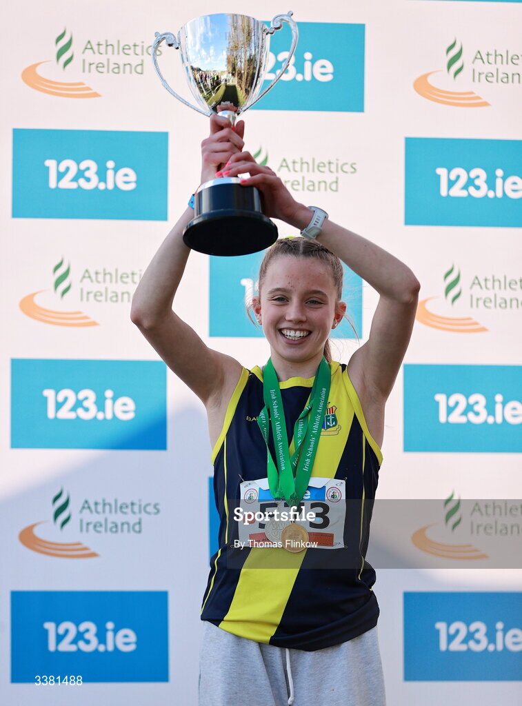 7 March 2026; Freya Renton of Sacred Heart School Westport, Mayo, lifts the Rory Friel Memorial Trophy after the 123.ie All Ireland Schools’ Cross Country Championships at Mallusk Playing Fields in Newtownabbey, Antrim. Photo by Thomas Flinkow/Sportsfile