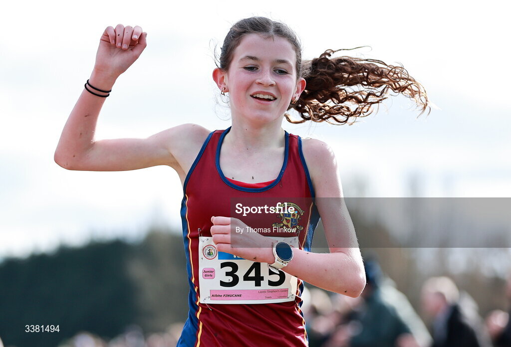 7 March 2026; Ailbhe Finucane of Loreto Stephen's Green, Dublin, celebrates at the finish line after winning the junior girls event during the 123.ie All Ireland Schools’ Cross Country Championships at Mallusk Playing Fields in Newtownabbey, Antrim. Photo by Thomas Flinkow/Sportsfile