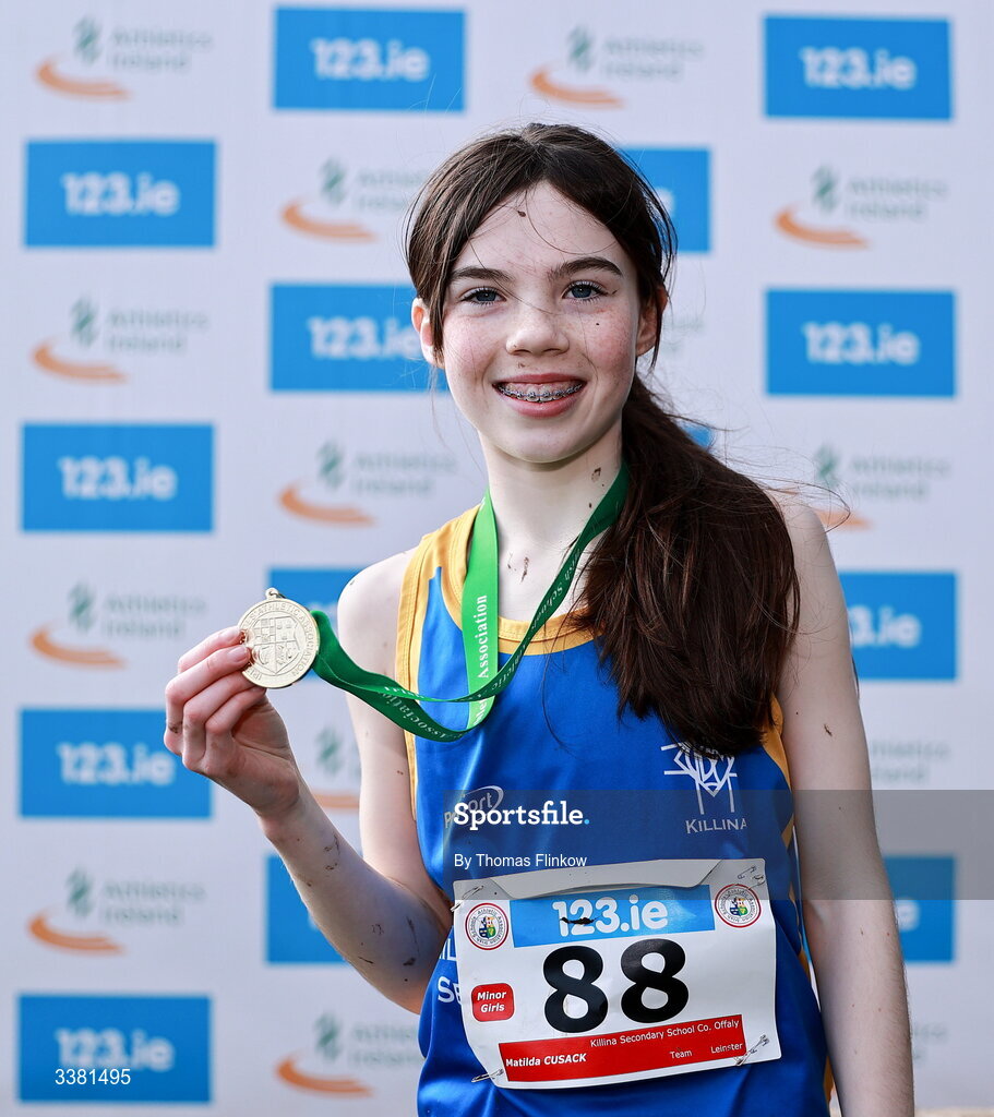 7 March 2026; Matilda Cusack of Killina Secondary School Co. Offaly celebrates with her gold medal after winning the minor girls event during the 123.ie All Ireland Schools’ Cross Country Championships at Mallusk Playing Fields in Newtownabbey, Antrim. Photo by Thomas Flinkow/Sportsfile
