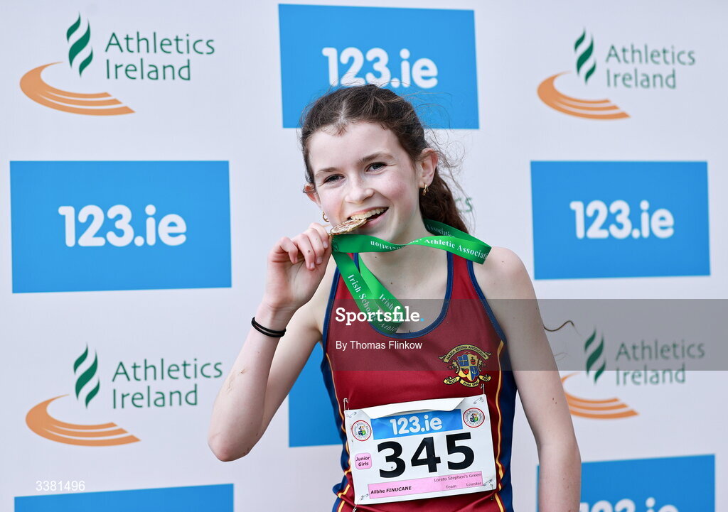7 March 2026; Ailbhe Finucane of Loreto Stephen's Green, Dublin, celebrates with her gold medal after winning the junior girls event during the 123.ie All Ireland Schools’ Cross Country Championships at Mallusk Playing Fields in Newtownabbey, Antrim. Photo by Thomas Flinkow/Sportsfile