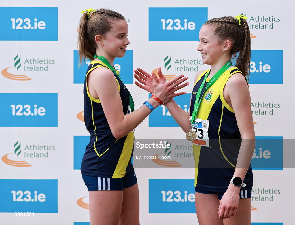 7 March 2026; Freya Renton of Sacred Heart School Westport, Mayo, right, celebrates with her sister Holly after winning the inter girls event during the 123.ie All Ireland Schools’ Cross Country Championships at Mallusk Playing Fields in Newtownabbey, Antrim. Photo by Thomas Flinkow/Sportsfile