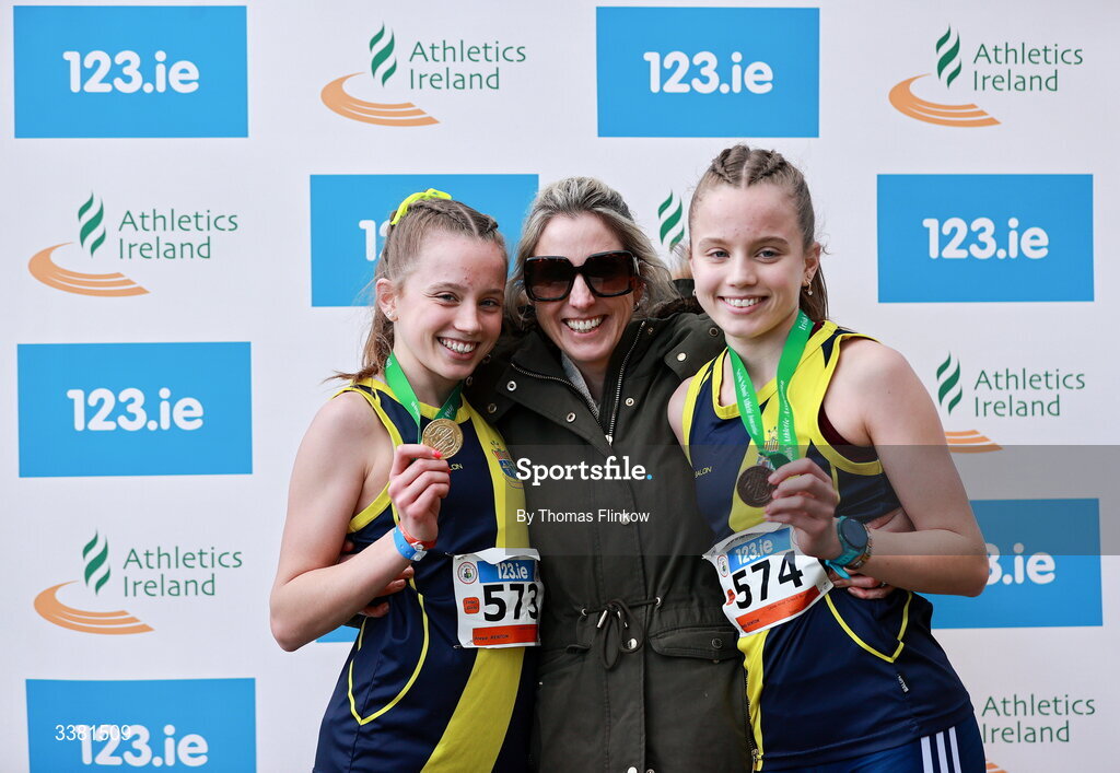 7 March 2026; Freya Renton of Sacred Heart School Westport, Mayo, left, celebrates with her sister Holly and mother Philippa after winning the inter girls event during the 123.ie All Ireland Schools’ Cross Country Championships at Mallusk Playing Fields in Newtownabbey, Antrim. Photo by Thomas Flinkow/Sportsfile