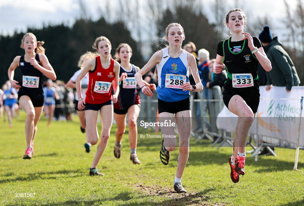 7 March 2026; Aoife Connor of St Josephs Castlebar, Mayo, 288, and Leah O'Callaghan of Castleknock Community College, Dublin, 333, compete in the junior girls event during the 123.ie All Ireland Schools’ Cross Country Championships at Mallusk Playing Fields in Newtownabbey, Antrim. Photo by Thomas Flinkow/Sportsfile