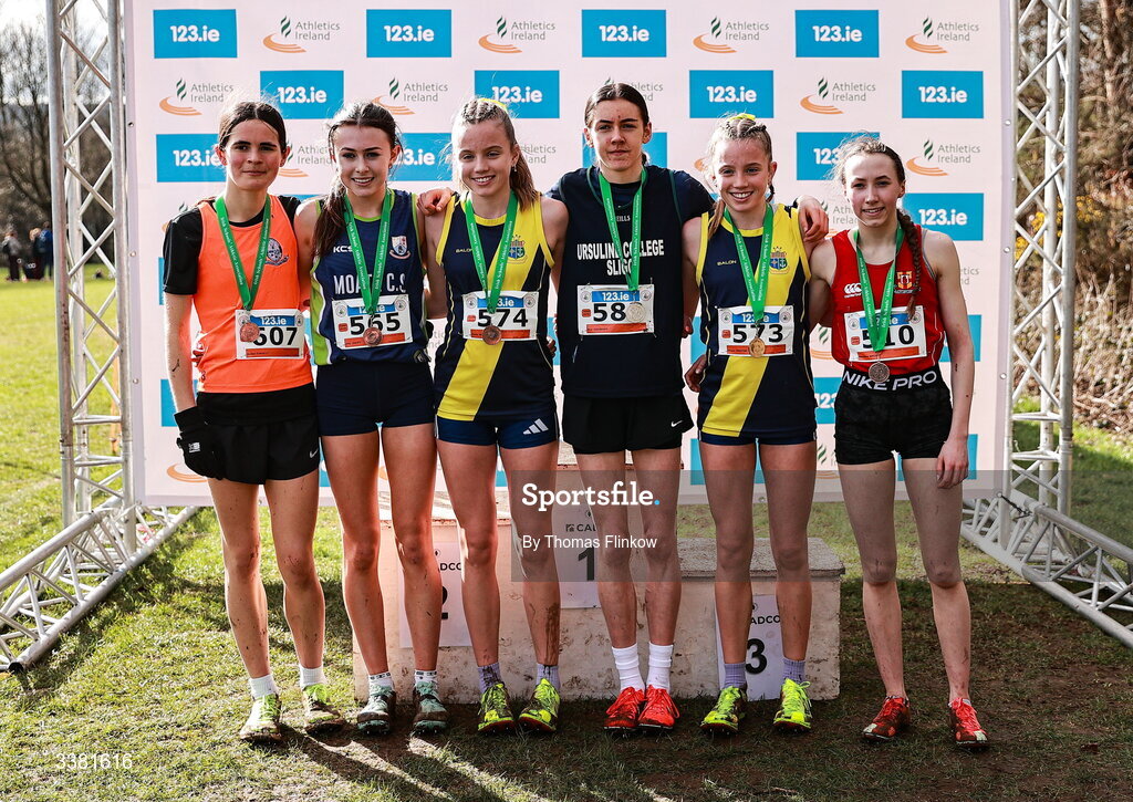7 March 2026; Gold medalist Freya Renton of Sacred Heart School Westport, Mayo, second from right, with Ava Colreavy of Ursuline College, Sligo, third from right,  Madison Welby of Friends' School Lisburn, Antrim, right, and, from left, Eimear O'Reagan of Dominican Col Belfast, Antrim, Ally Duffy of Moate Community School, Westmeath, and Holly Renton of Sacred Heart School Westport, Mayo,  after the inter girls event during the 123.ie All Ireland Schools’ Cross Country Championships at Mallusk Playing Fields in Newtownabbey, Antrim. Photo by Thomas Flinkow/Sportsfile