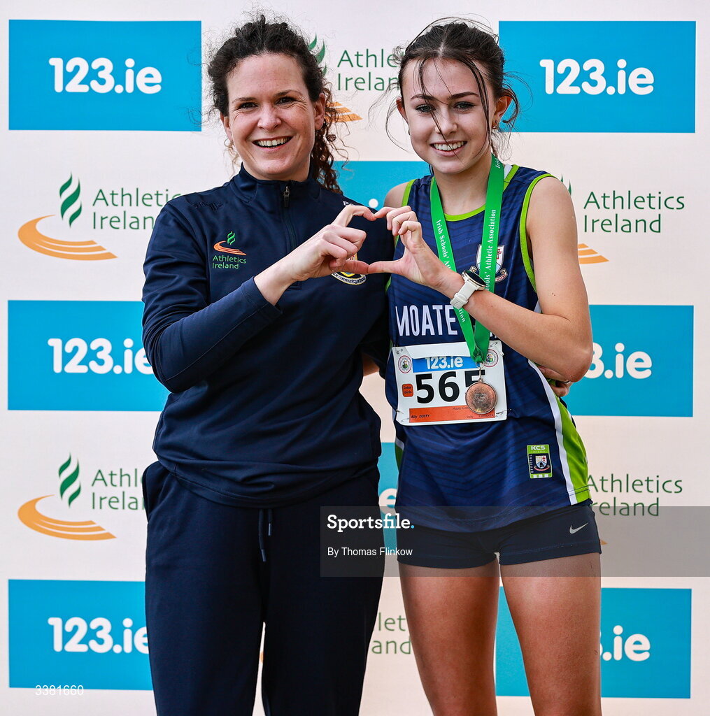 7 March 2026; Ally Duffy of Moate Community School, Westmeath, with coach Eimear Gaffey after competing in the inter girls event during the 123.ie All Ireland Schools’ Cross Country Championships at Mallusk Playing Fields in Newtownabbey, Antrim. Photo by Thomas Flinkow/Sportsfile