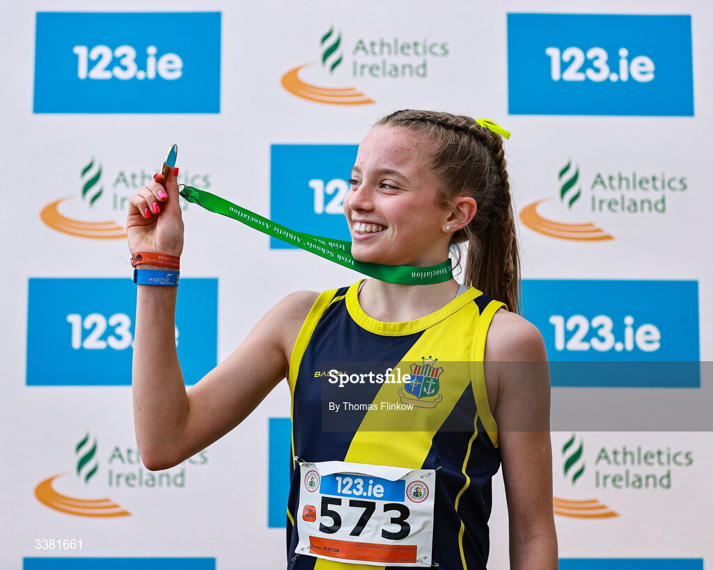 7 March 2026; Freya Renton of Sacred Heart School Westport, Mayo, celebrates with her gold medal after winning the inter girls event during the 123.ie All Ireland Schools’ Cross Country Championships at Mallusk Playing Fields in Newtownabbey, Antrim. Photo by Thomas Flinkow/Sportsfile