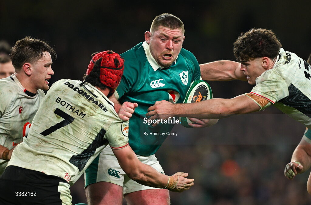 6 March 2026; Tadhg Furlong of Ireland is tackled by James Botham, left, and Eddie James of Wales during the Guinness 6 Nations Rugby Championship match between Ireland and Wales at the Aviva Stadium in Dublin. Photo by Ramsey Cardy/Sportsfile