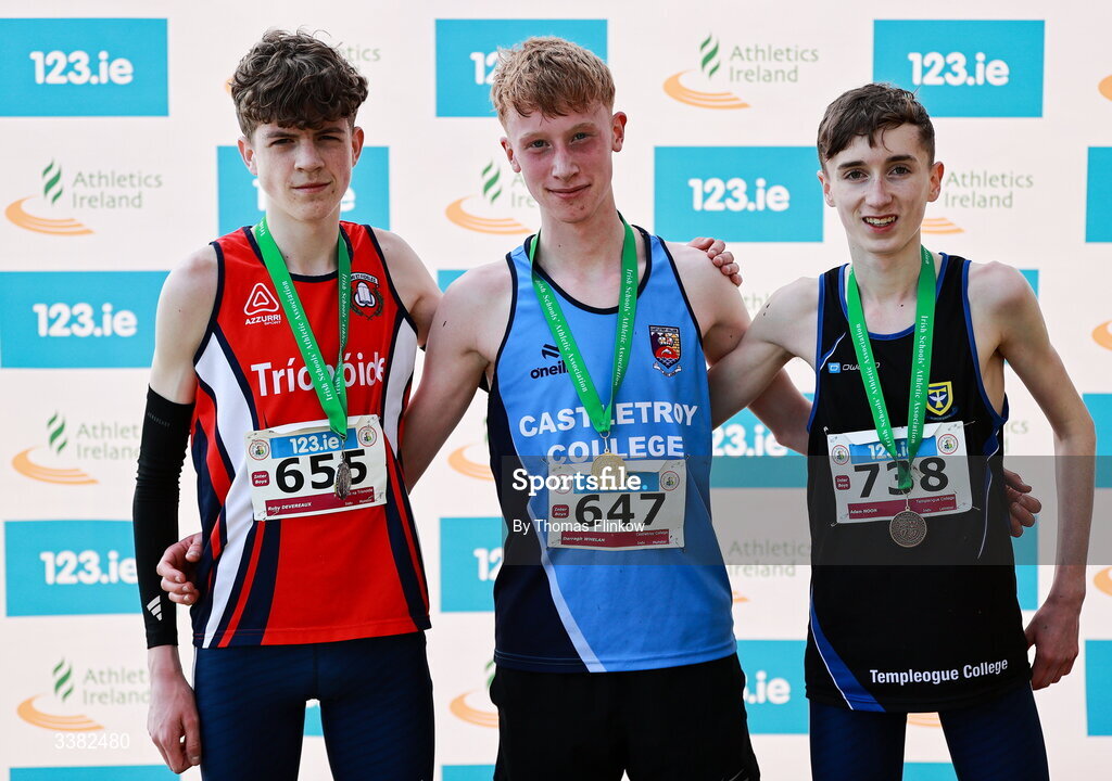 7 March 2026; Inter boys medalists Darragh Whelan of Castletroy College, Limerick, gold, Ruby Devereaux of Pobalscoil na Trionoide, Cork, silver, and Adam Noon of Templeogue College, Dublin, bronze during the 123.ie All Ireland Schools’ Cross Country Championships at Mallusk Playing Fields in Newtownabbey, Antrim. Photo by Thomas Flinkow/Sportsfile