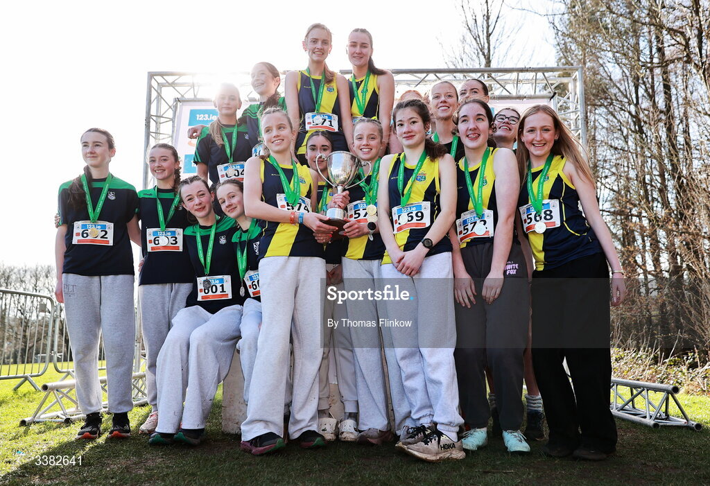 7 March 2026; Inter girls team medallists, Sacred Heart School Westport, Mayo, gold, Santa Sabina, Dublin, silver, and Newbridge College, bronze, celebrate after the 123.ie All Ireland Schools’ Cross Country Championships at Mallusk Playing Fields in Newtownabbey, Antrim. Photo by Thomas Flinkow/Sportsfile