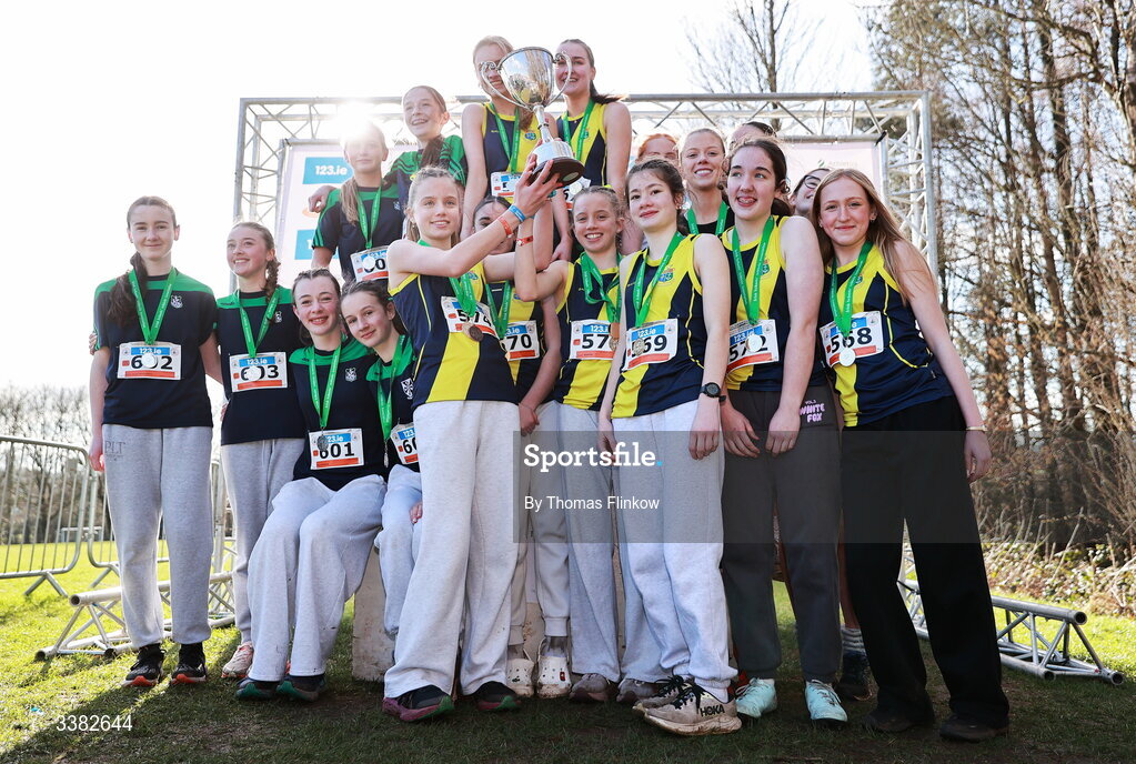 7 March 2026; Inter girls team medallists, Sacred Heart School Westport, Mayo, gold, Santa Sabina, Dublin, silver, and Newbridge College, bronze, celebrate after the 123.ie All Ireland Schools’ Cross Country Championships at Mallusk Playing Fields in Newtownabbey, Antrim. Photo by Thomas Flinkow/Sportsfile