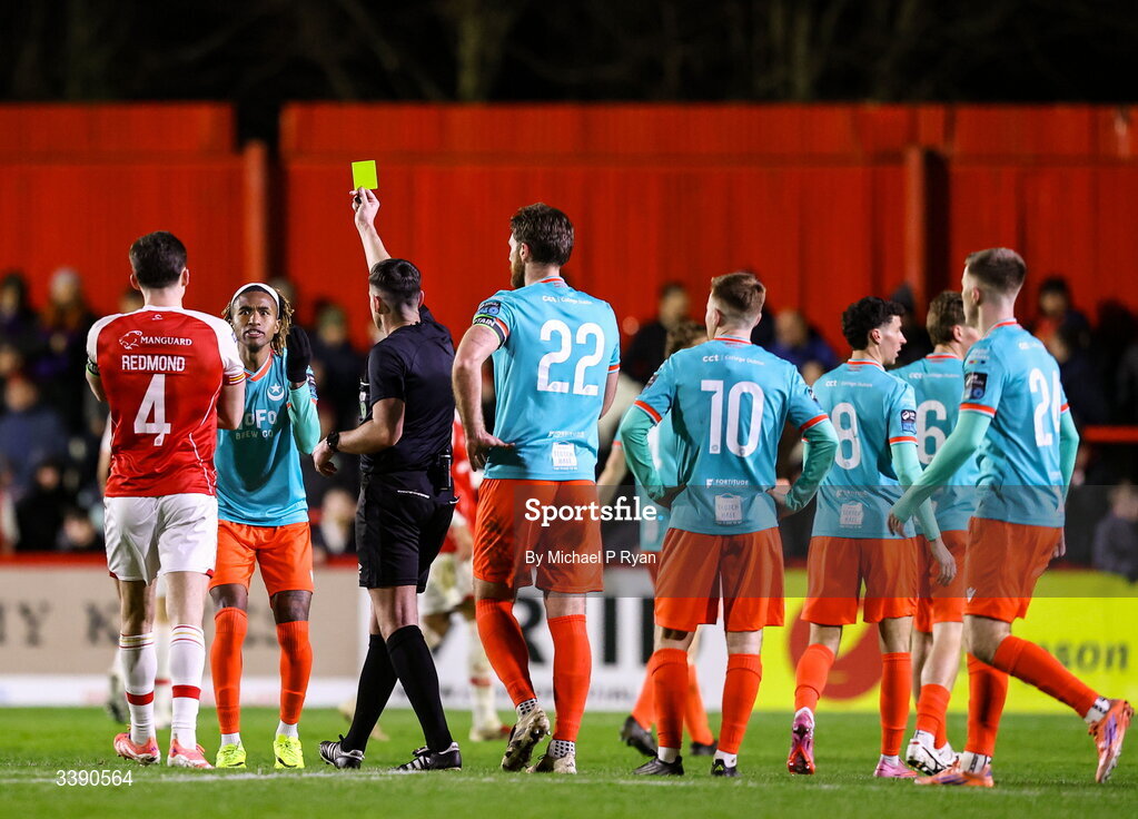 13 March 2026; Jason Bucknor of Drogheda United is shown a yellow card by referee Rob Hennessy during the SSE Airtricity Men's Premier Division match between St Patrick's Athletic and Drogheda United at Richmond Park in Dublin. Photo by Michael P Ryan/Sportsfile