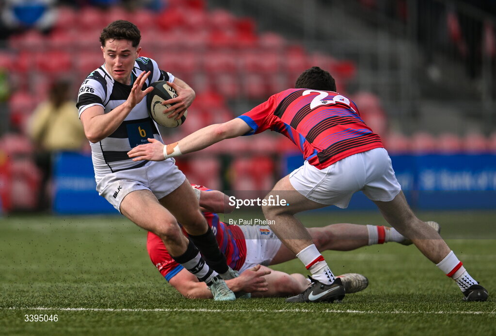 18 March 2026; Frankie Óg Sheahan of Presentation Brothers College is tackled by Brendan Minogue and Paddy O'Driscoll of St. Munchin’s College during the Pinergy Munster Schools Boys Senior Cup final match between Presentation Brothers College, Cork and St. Munchin’s College, Limerick at Virgin Media Park in Cork. Photo by Paul Phelan/Sportsfile