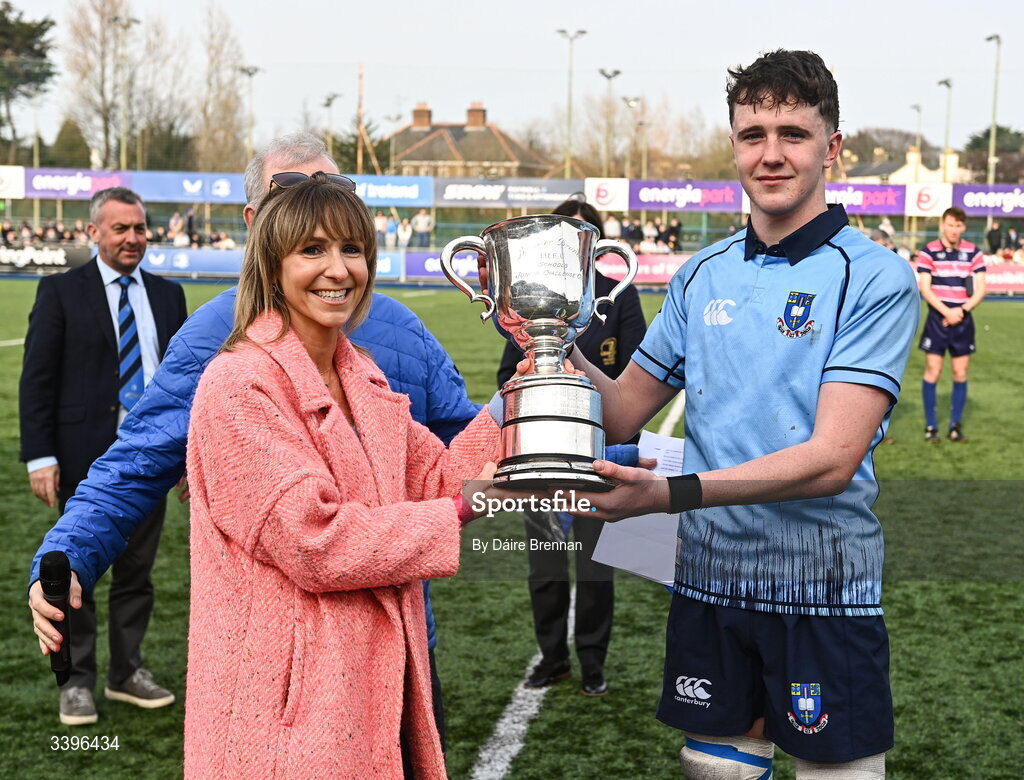 20 March 2026; St Michael's College captain Ryan O’Malley receives the cup from his mother Caitríona after the Bank of Ireland Leinster Rugby Boys Schools Junior Cup final match between St Mary's College and St Michael's College at Energia Park in Dublin. Photo by Daire Brennan/Sportsfile
