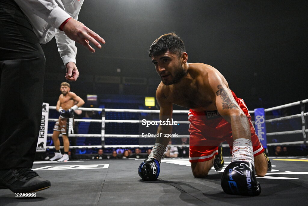 20 March 2026; Carlos Daniel Cordoba takes a count from the referee against Ben Marksby, far left, during their super lightweight bout at the SSE Arena in Belfast. Photo by David Fitzgerald/Sportsfile