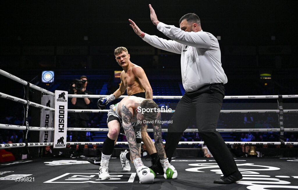 20 March 2026; Referee Eamonn Magill stops the fight between Codie Smith and Lee Gormley during their super featherweight bout at the SSE Arena in Belfast. Photo by David Fitzgerald/Sportsfile
