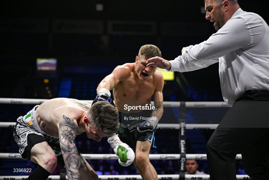 20 March 2026; Referee Eamonn Magill stops the fight between Codie Smith and Lee Gormley during their super featherweight bout at the SSE Arena in Belfast. Photo by David Fitzgerald/Sportsfile